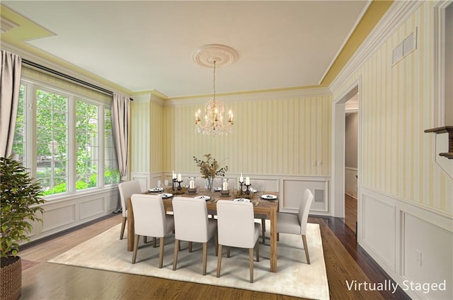 dining area with a decorative wall, dark wood finished floors, ornamental molding, wallpapered walls, and a chandelier