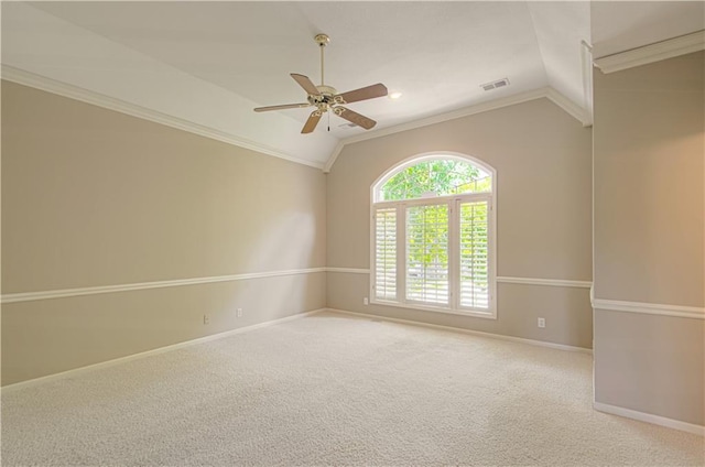 carpeted empty room featuring lofted ceiling, a ceiling fan, crown molding, and baseboards