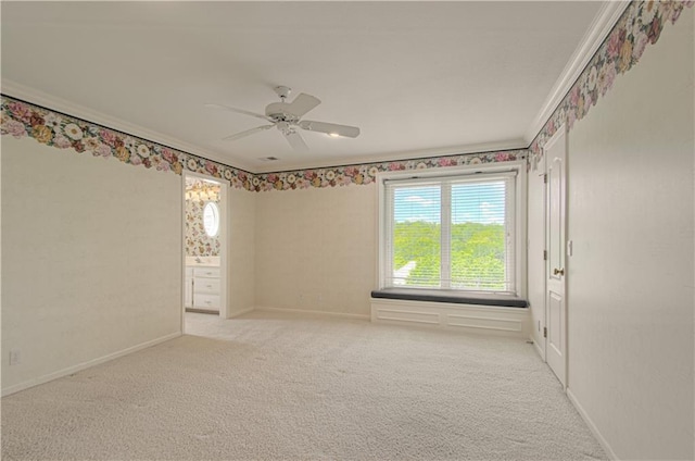 empty room featuring crown molding, a ceiling fan, light carpet, and baseboards