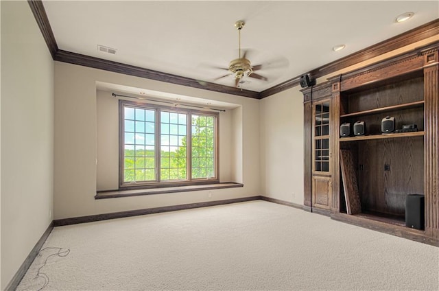 unfurnished living room featuring ornamental molding, a ceiling fan, carpet floors, and baseboards