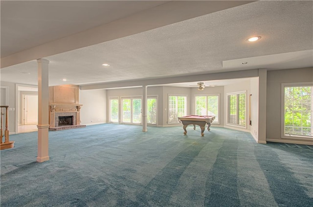 unfurnished living room featuring carpet floors, billiards table, baseboards, a textured ceiling, and recessed lighting