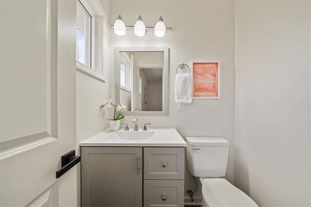 half bathroom featuring toilet and vanity