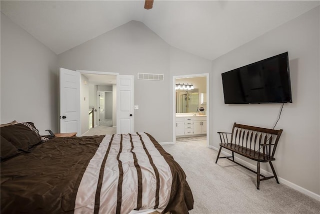 bedroom with visible vents, baseboards, high vaulted ceiling, light colored carpet, and connected bathroom