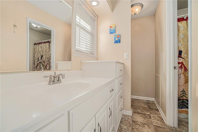 full bath with baseboards and vanity