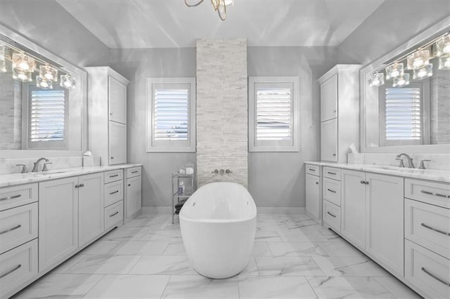 2189 W 89th Pl, Leawood, KS 66206 - bathroom with two vanities, plenty of natural light, marble finish floor, and a sink