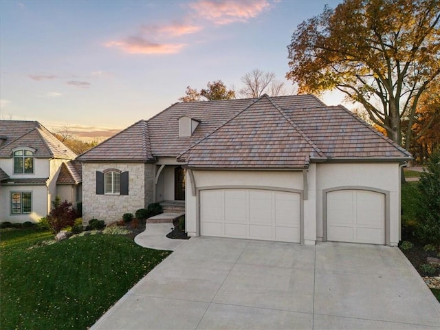 2189 W 89th Pl, Leawood, KS 66206 - view of front of house with concrete driveway, stucco siding, stone siding, an attached garage, and a front lawn