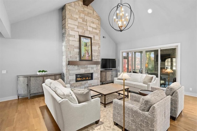 2189 W 89th Pl, Leawood, KS 66206 - living room featuring a stone fireplace, high vaulted ceiling, a chandelier, and wood finished floors