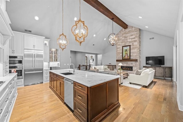2189 W 89th Pl, Leawood, KS 66206 - kitchen featuring a sink, visible vents, appliances with stainless steel finishes, and a notable chandelier