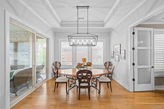 2189 W 89th Pl, Leawood, KS 66206 - dining space featuring a tray ceiling, an inviting chandelier, visible vents, and light wood finished floors