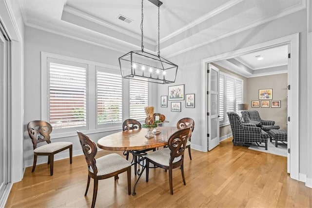 2189 W 89th Pl, Leawood, KS 66206 - dining space with light wood finished floors, visible vents, a notable chandelier, and a tray ceiling