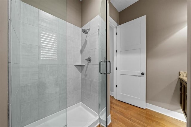 2189 W 89th Pl, Leawood, KS 66206 - bathroom featuring a shower stall, wood finished floors, vanity, and baseboards