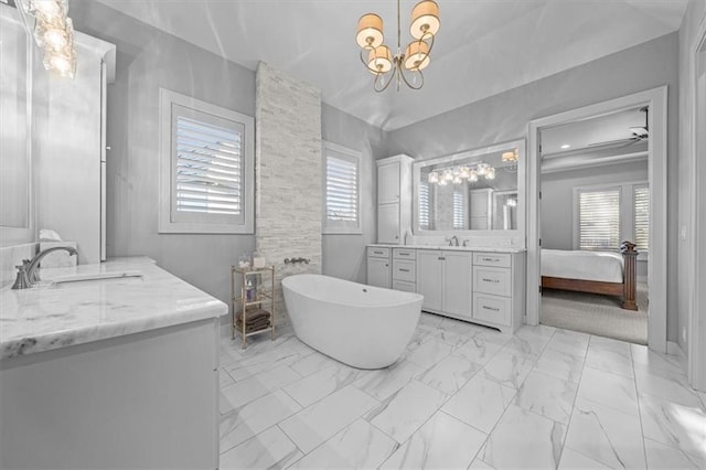 2189 W 89th Pl, Leawood, KS 66206 - ensuite bathroom with a sink, marble finish floor, a soaking tub, and an inviting chandelier