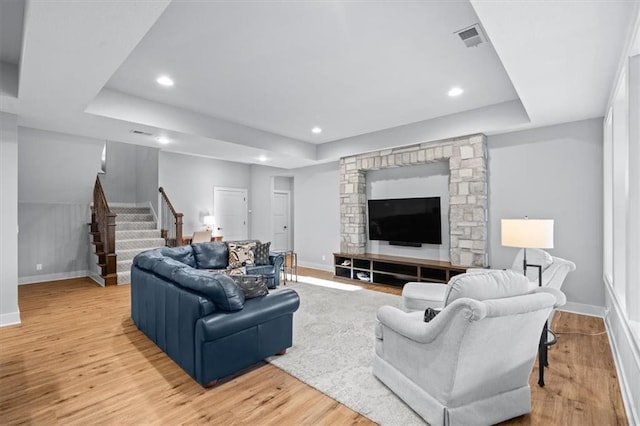 2189 W 89th Pl, Leawood, KS 66206 - living area with stairway, light wood-type flooring, a raised ceiling, baseboards, and visible vents