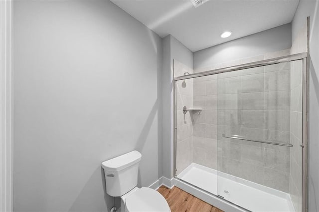 2189 W 89th Pl, Leawood, KS 66206 - bathroom with baseboards, toilet, wood finished floors, and a stall shower