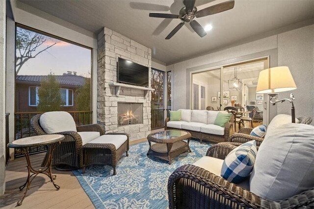 2189 W 89th Pl, Leawood, KS 66206 - living room with wood finished floors, a ceiling fan, and an outdoor stone fireplace