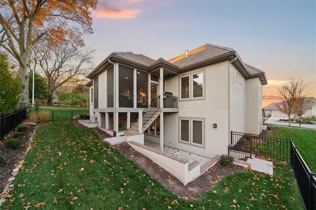 2189 W 89th Pl, Leawood, KS 66206 - back of property featuring a patio, stairway, a sunroom, and a lawn