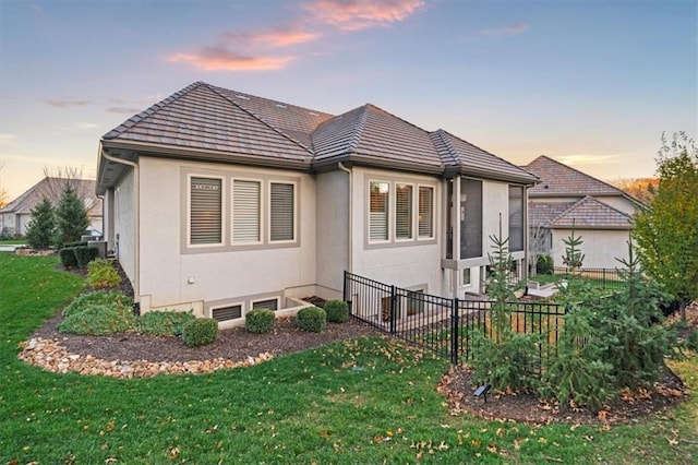 2189 W 89th Pl, Leawood, KS 66206 - exterior space with a tiled roof, a front lawn, stucco siding, and fence