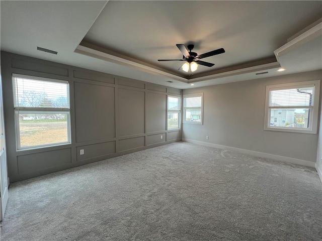 16941 S Brentwood St, Olathe, KS 66062 - carpeted spare room with a decorative wall, a raised ceiling, baseboards, and a ceiling fan
