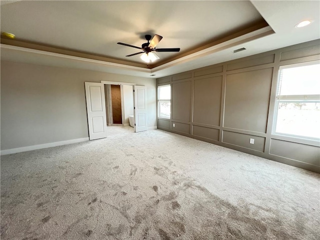 16941 S Brentwood St, Olathe, KS 66062 - unfurnished bedroom with carpet flooring, a decorative wall, visible vents, and a raised ceiling