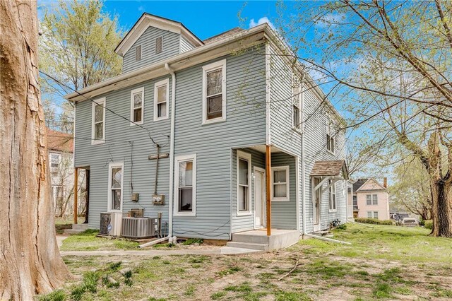 rear view of house featuring central AC unit