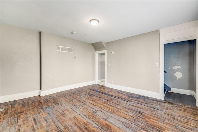 interior space with visible vents, baseboards, and wood finished floors