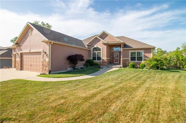 ranch-style home featuring stone siding, stucco siding, a garage, driveway, and a front yard