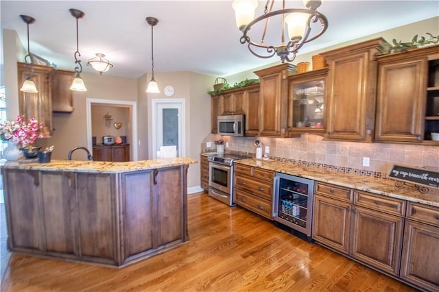 kitchen with wine cooler, stainless steel appliances, brown cabinetry, and tasteful backsplash