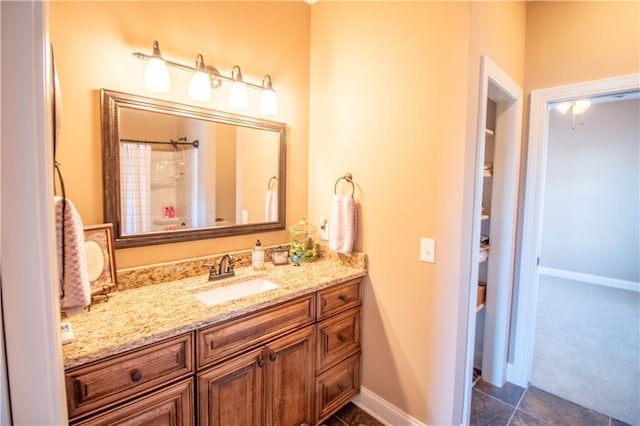 bathroom featuring baseboards, vanity, and a shower with shower curtain