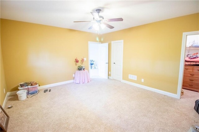 unfurnished bedroom with carpet, baseboards, and a ceiling fan