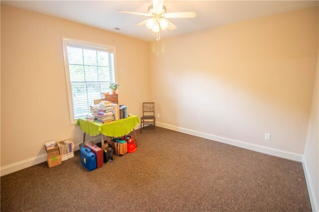 recreation room featuring carpet flooring, a ceiling fan, and baseboards