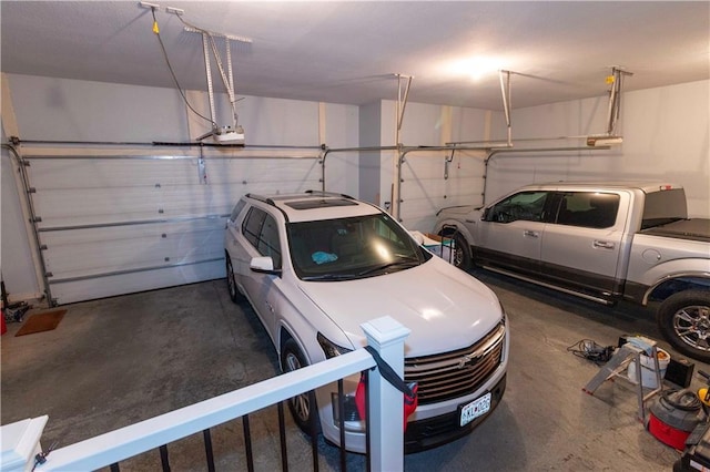 garage with a garage door opener and independent washer and dryer