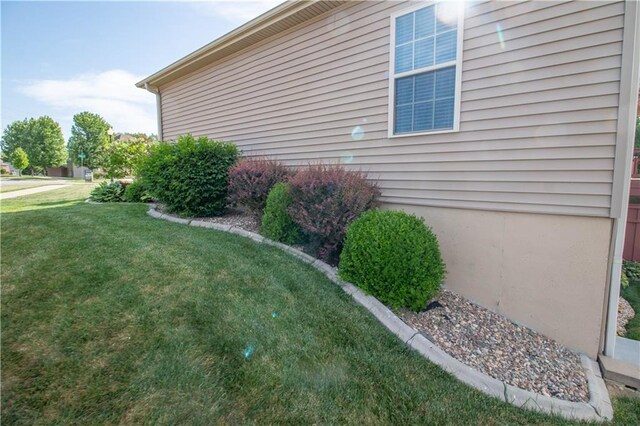 view of property exterior featuring a lawn
