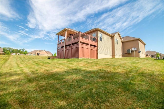 rear view of property with a lawn and a deck