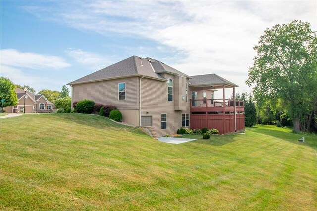 view of side of property featuring a yard and a deck