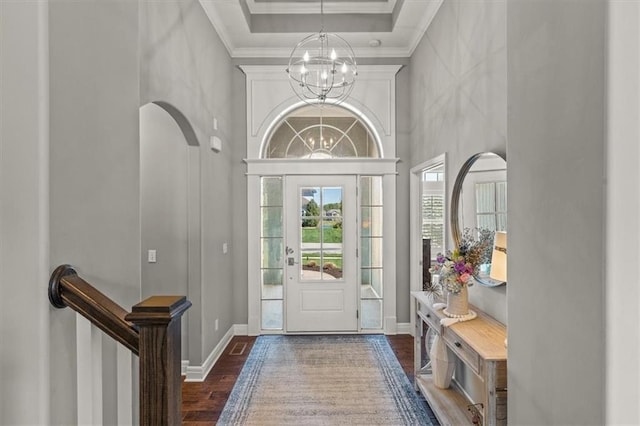 9874 Belmont Dr, Lenexa, KS 66227 - entrance foyer featuring wood finished floors, a chandelier, a high ceiling, crown molding, and baseboards
