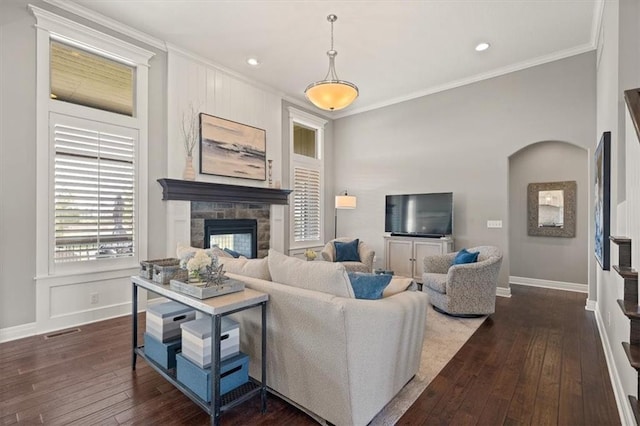 9874 Belmont Dr, Lenexa, KS 66227 - living room featuring ornamental molding, dark wood finished floors, baseboards, a stone fireplace, and recessed lighting