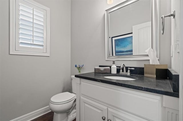 9874 Belmont Dr, Lenexa, KS 66227 - bathroom with vanity, toilet, and baseboards