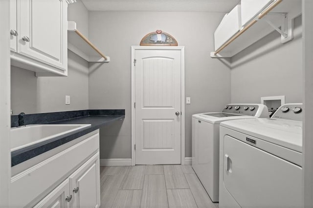9874 Belmont Dr, Lenexa, KS 66227 - laundry area featuring washer and clothes dryer, cabinet space, and baseboards