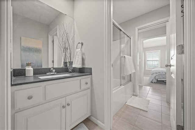 9874 Belmont Dr, Lenexa, KS 66227 - ensuite bathroom with vanity, bath / shower combo with glass door, and tile patterned floors