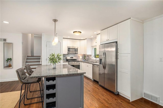 7620 Windsor St, Prairie Village, KS 66208 - kitchen with visible vents, stone countertops, tasteful backsplash, a sink, and stainless steel appliances