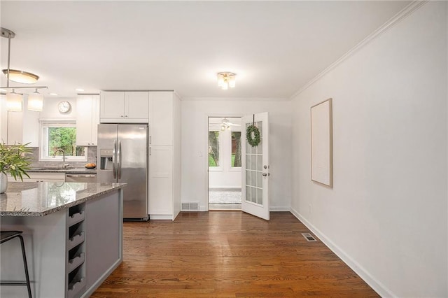 7620 Windsor St, Prairie Village, KS 66208 - kitchen featuring visible vents, light stone countertops, baseboards, white cabinetry, and appliances with stainless steel finishes