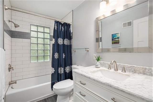 7620 Windsor St, Prairie Village, KS 66208 - full bathroom with vanity, toilet, shower / bath combination with curtain, wood finished floors, and visible vents