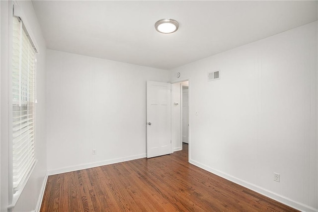 7620 Windsor St, Prairie Village, KS 66208 - unfurnished bedroom with baseboards, wood finished floors, and visible vents