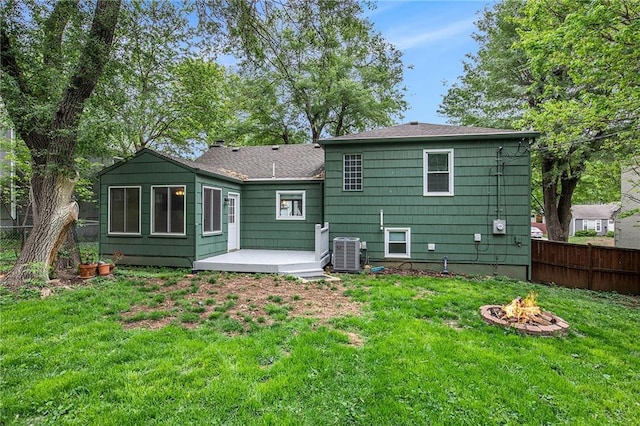 7620 Windsor St, Prairie Village, KS 66208 - rear view of house featuring a lawn, a fire pit, fence, and cooling unit