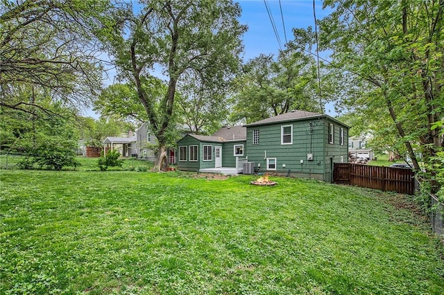 7620 Windsor St, Prairie Village, KS 66208 - rear view of house featuring fence, a lawn, and cooling unit