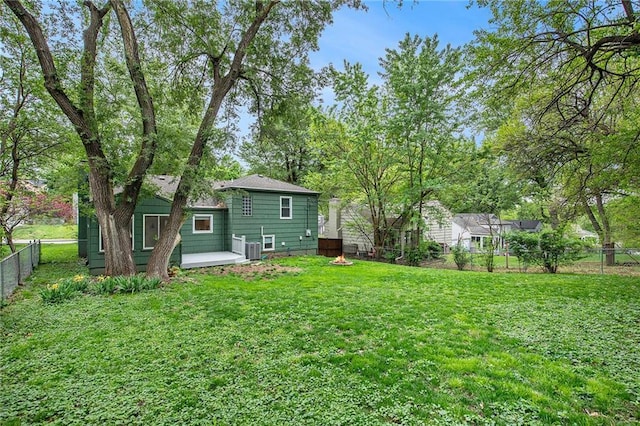 7620 Windsor St, Prairie Village, KS 66208 - view of yard featuring central air condition unit, a deck, and a fenced backyard