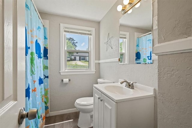 1340 E 85th St, Kansas City, MO 64131 - full bath featuring a textured wall, vanity, and wood finished floors