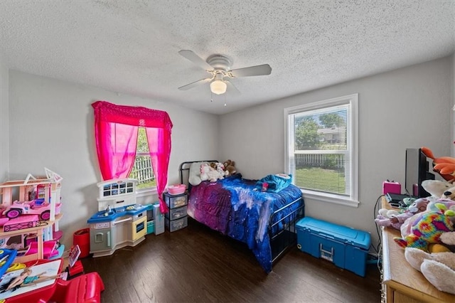 1340 E 85th St, Kansas City, MO 64131 - bedroom with multiple windows, hardwood / wood-style flooring, a textured ceiling, and a ceiling fan