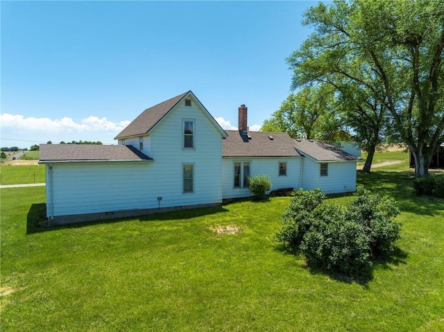 4933 SE Stubbs Rd, Tecumseh, KS 66542 - rear view of property with a lawn and a chimney