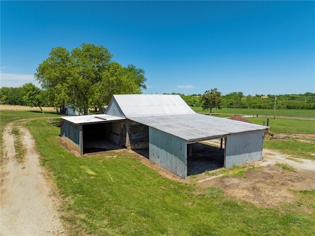 4933 SE Stubbs Rd, Tecumseh, KS 66542 - view of pole building featuring a lawn and a carport